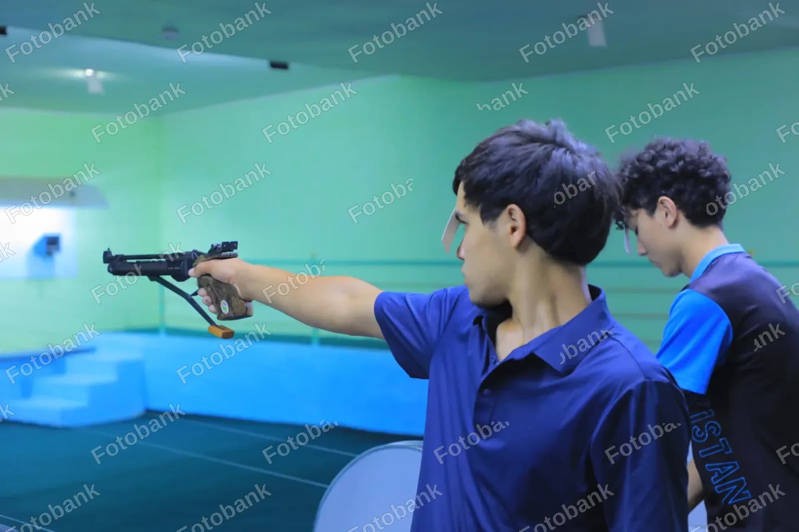 Young athletes practice air pistol