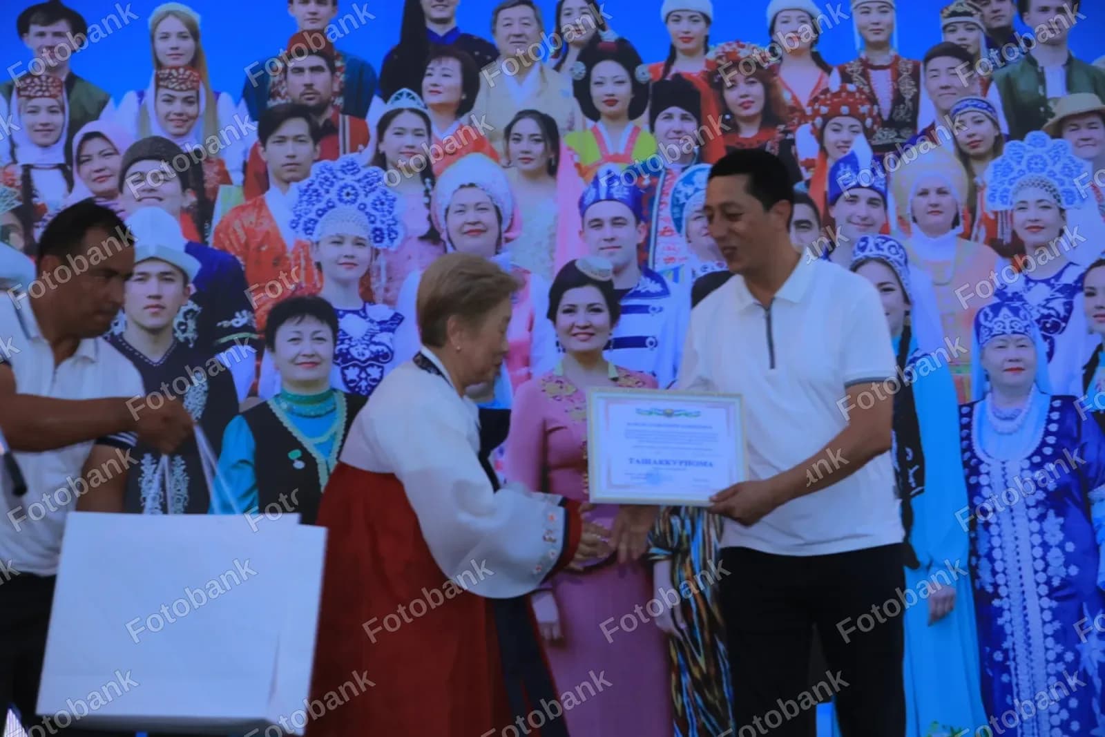 Man receives certificate during ceremony
