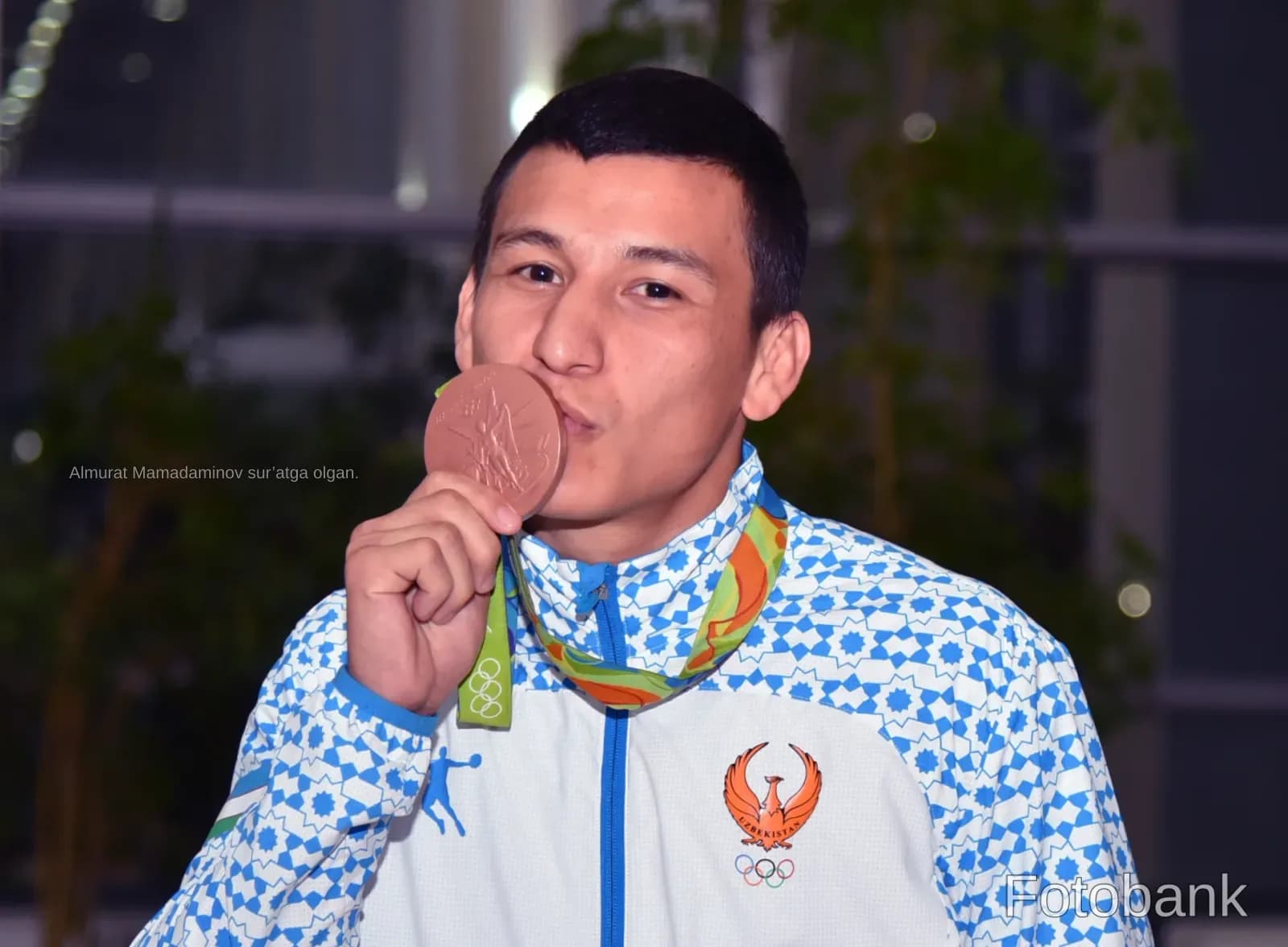 Athlete kissing a medal