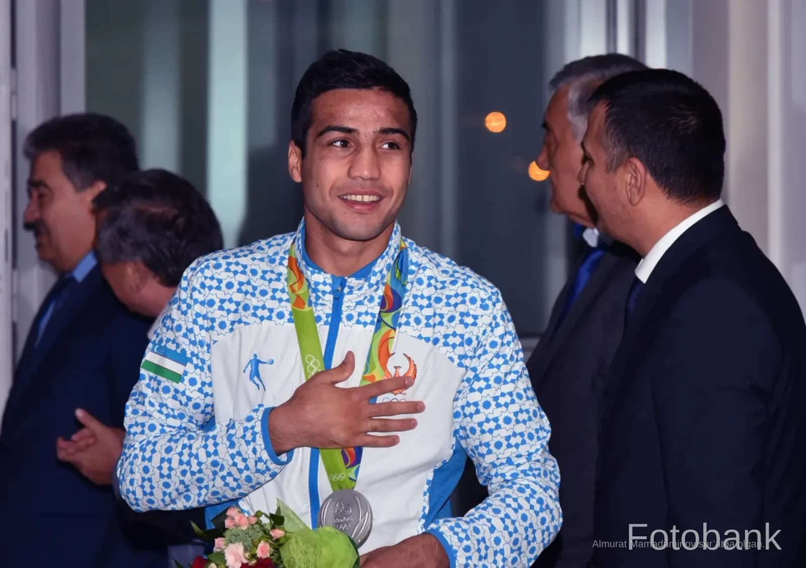 Athlete wearing a medal and sports jacket