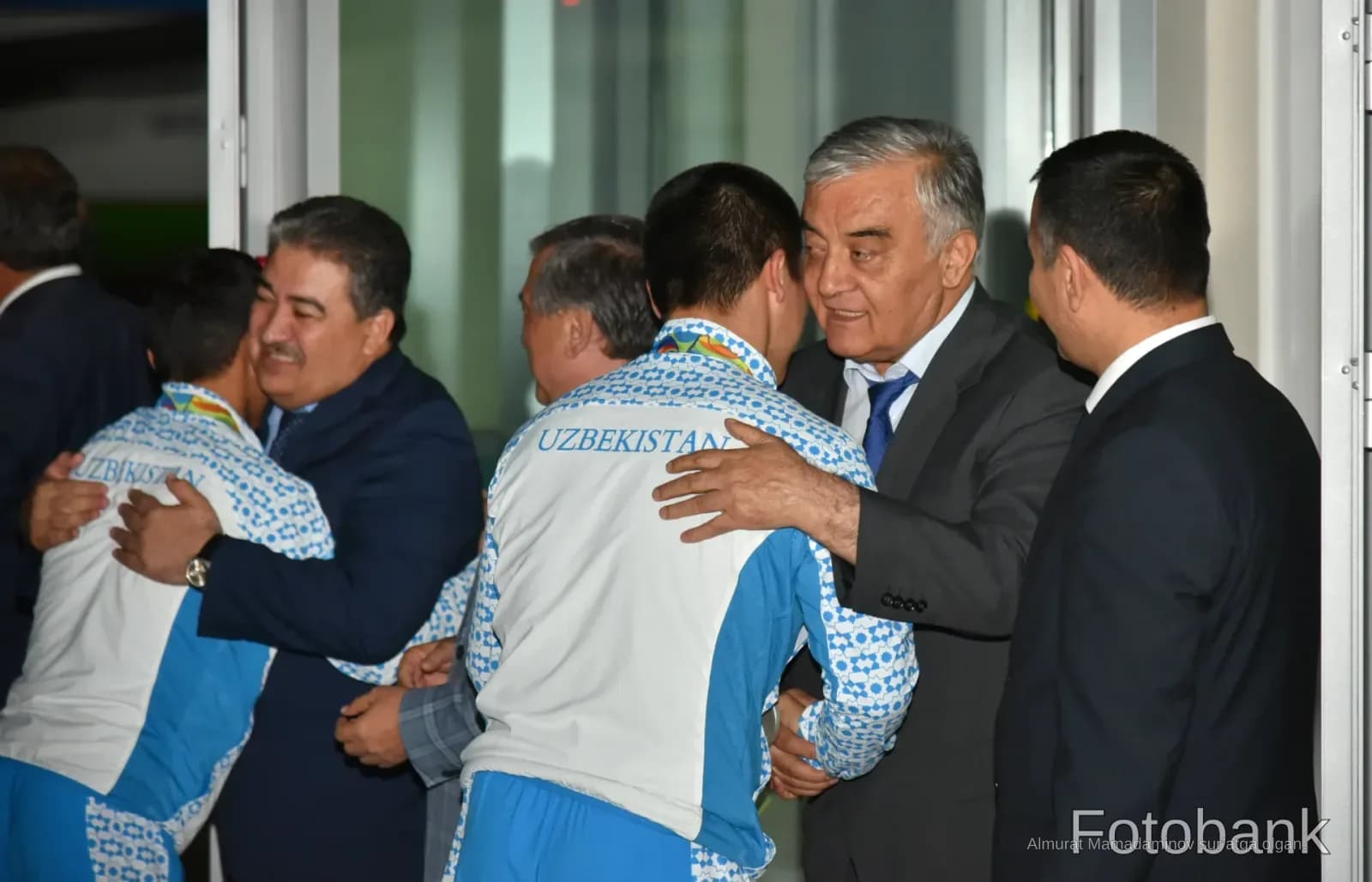 People greeting each other indoors