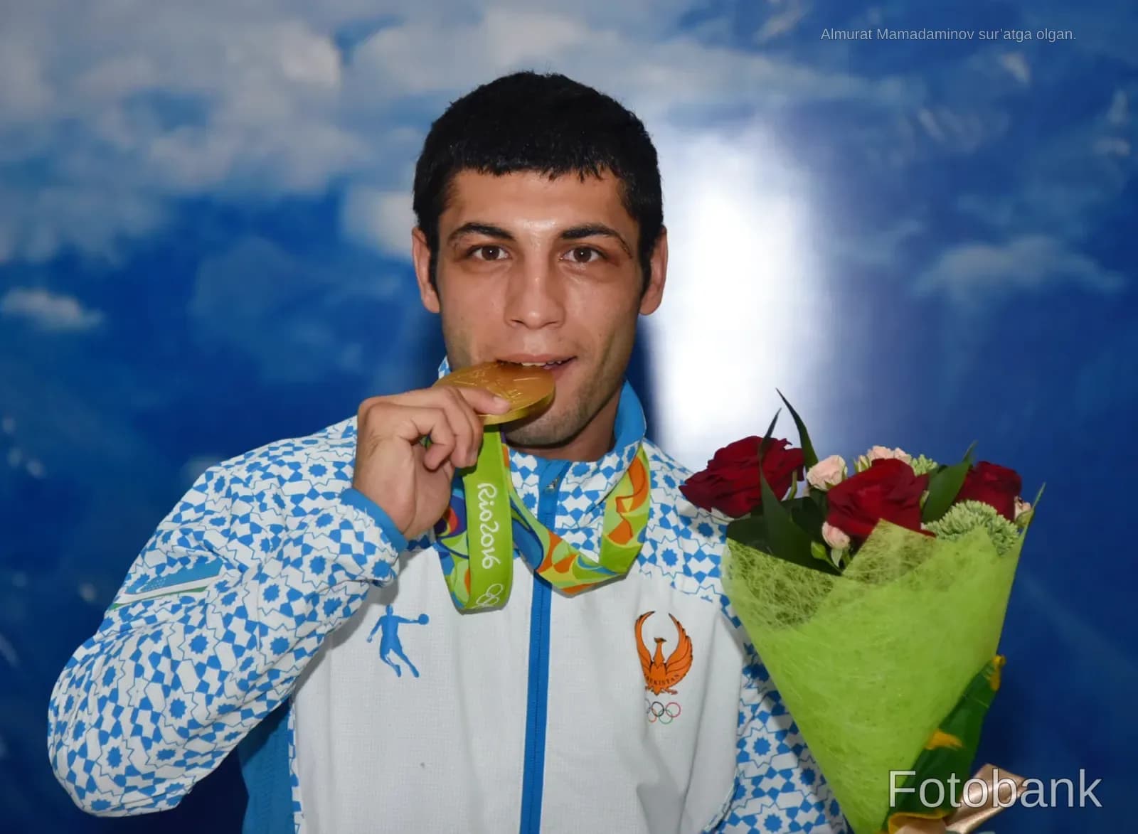 Athlete biting a medal while holding a bouquet of flowers