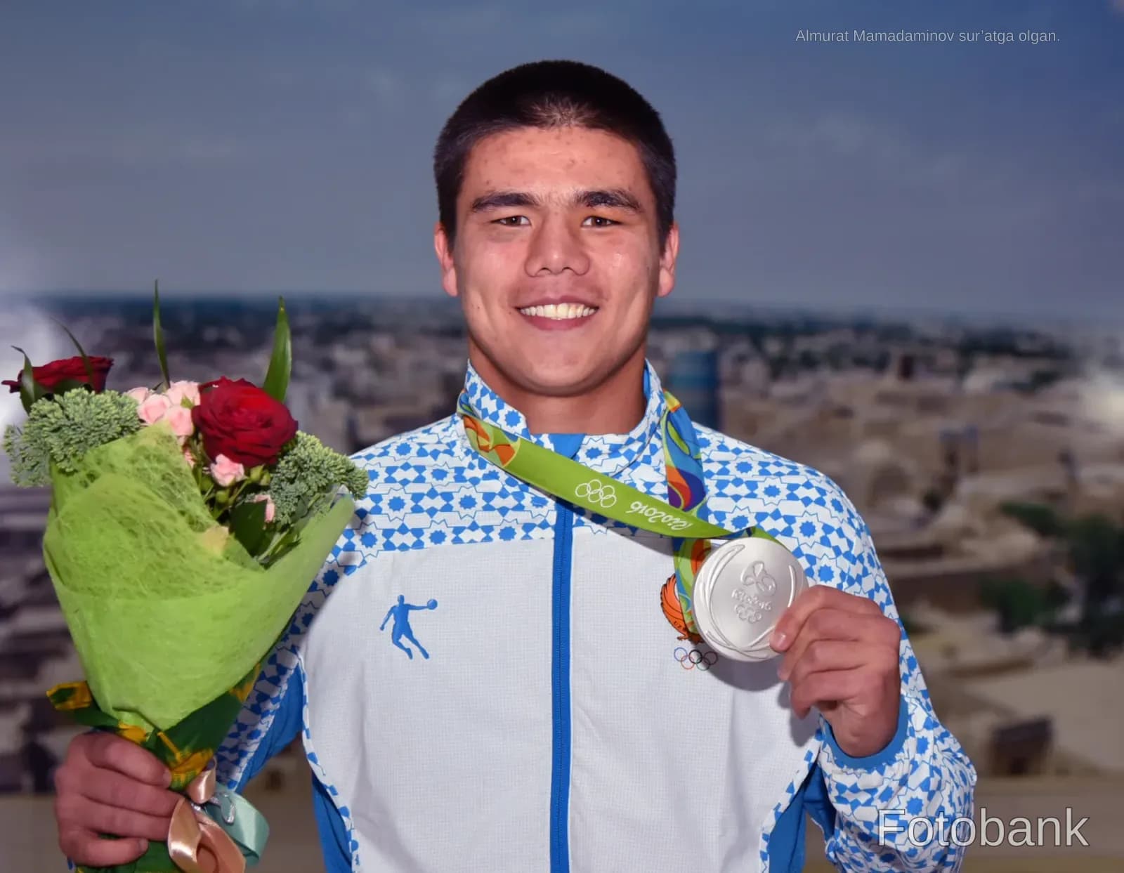 Portrait of an athlete holding a medal and flowers