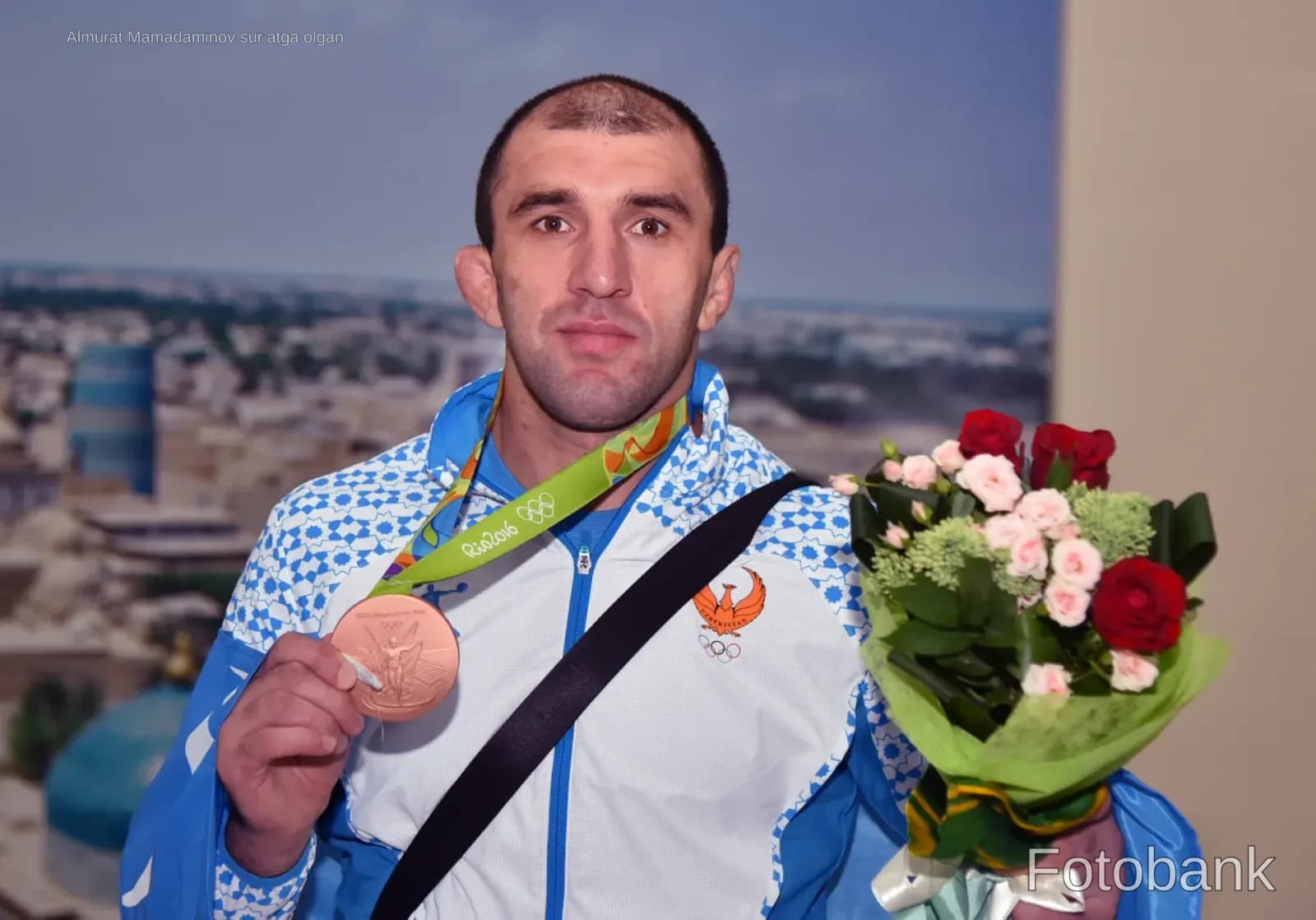 Athlete holding a medal and flowers