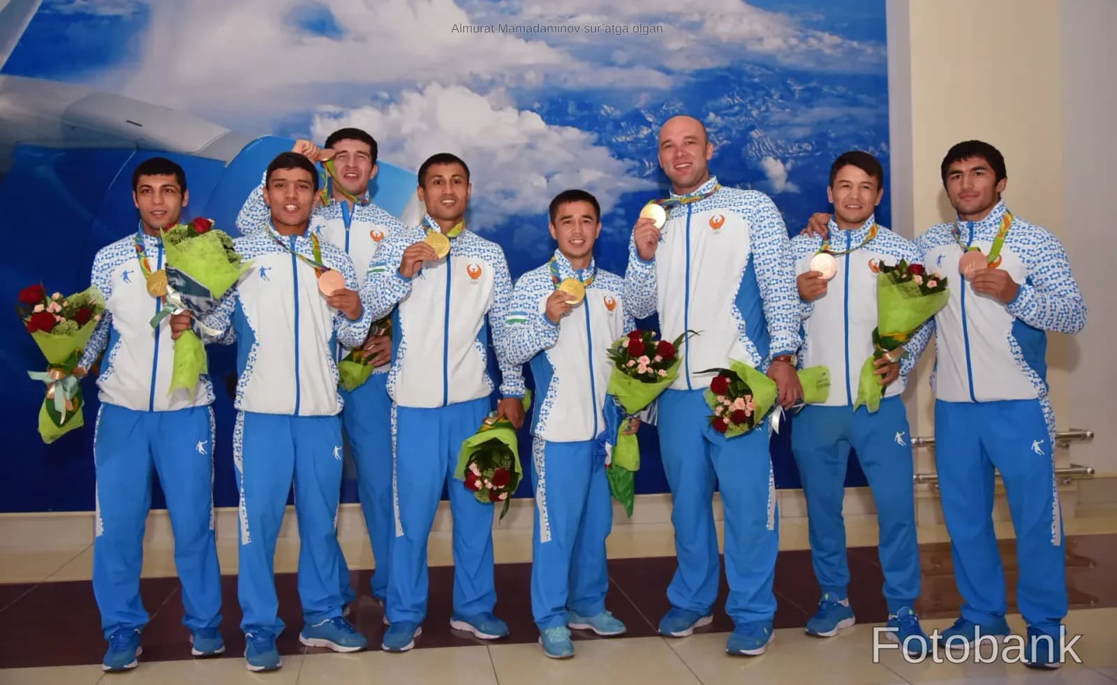 Group photo of athletes holding medals