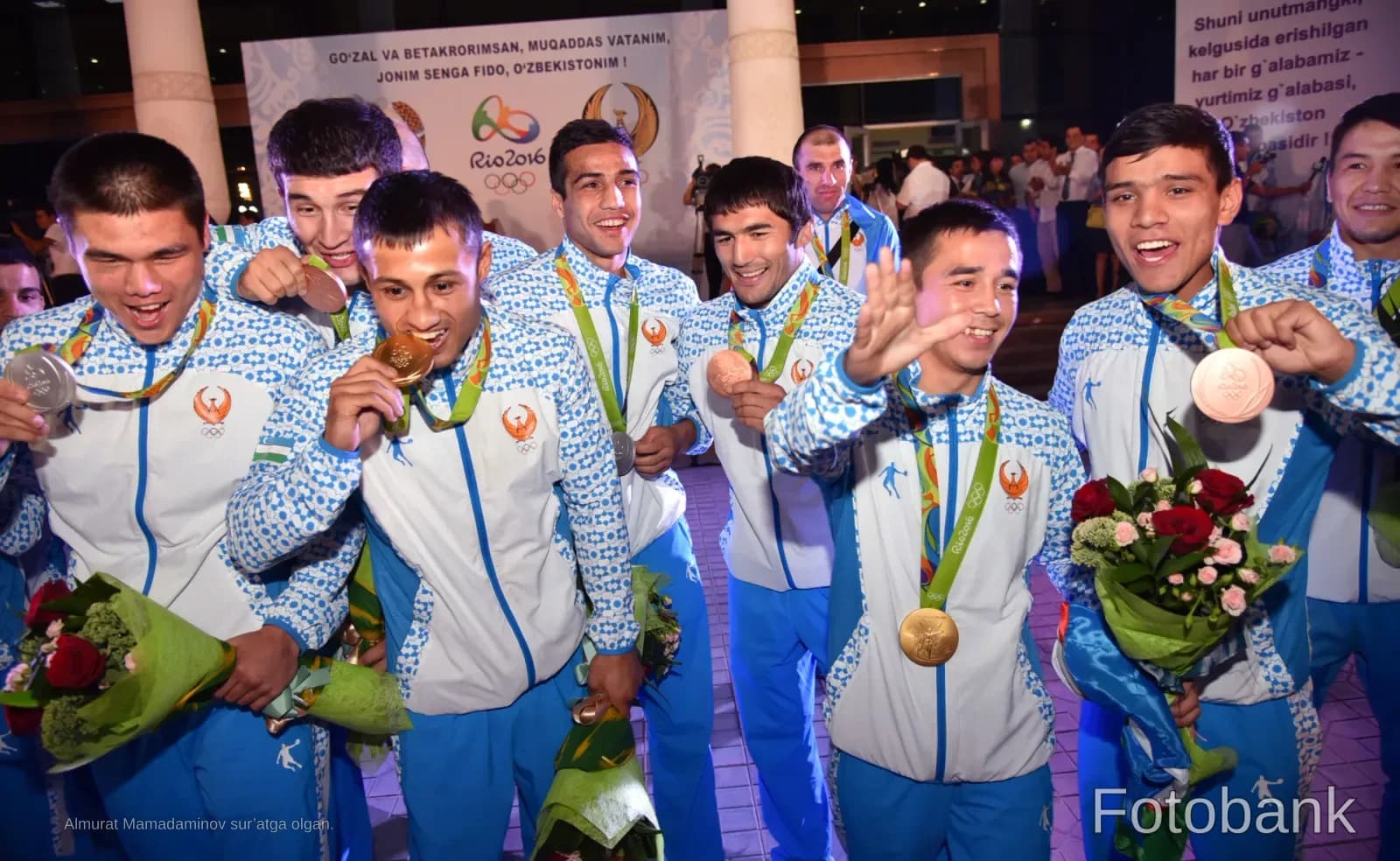 Athletes in sportswear holding medals and flowers