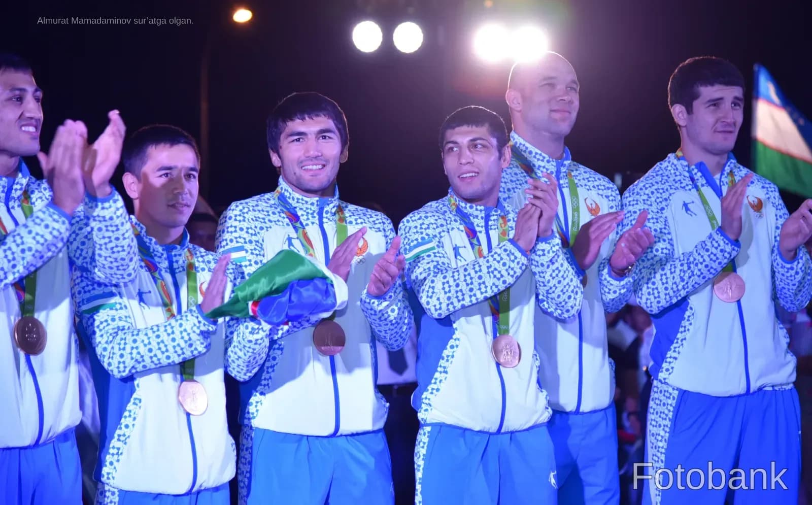 Athletes in sportswear with medals