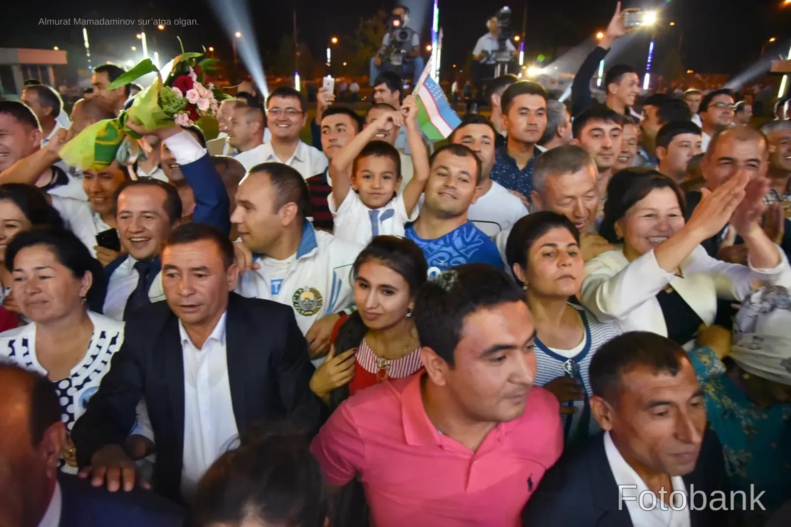 Crowd of people gathered outdoors at night