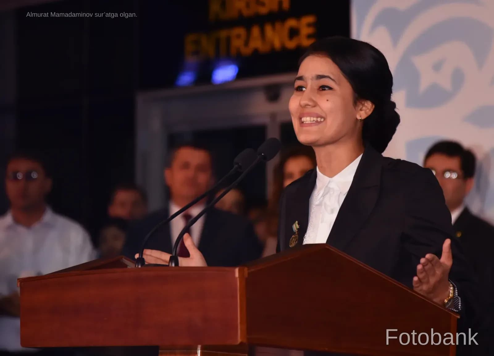 Young woman speaking at a podium during an event