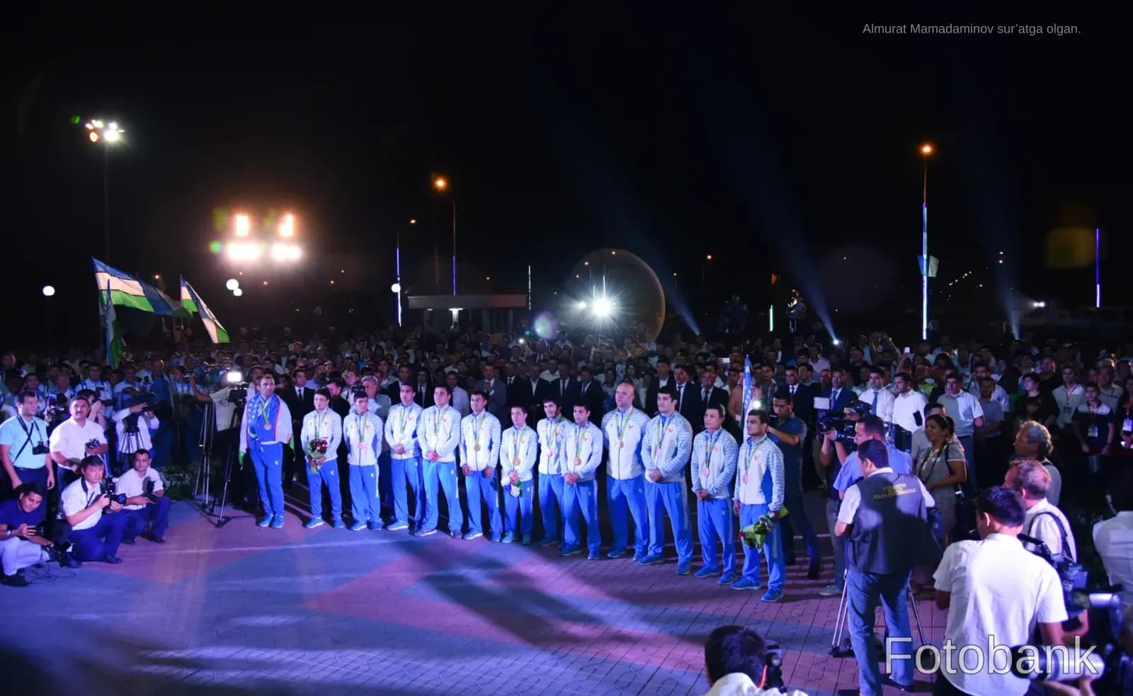 Group of athletes standing outdoors at night