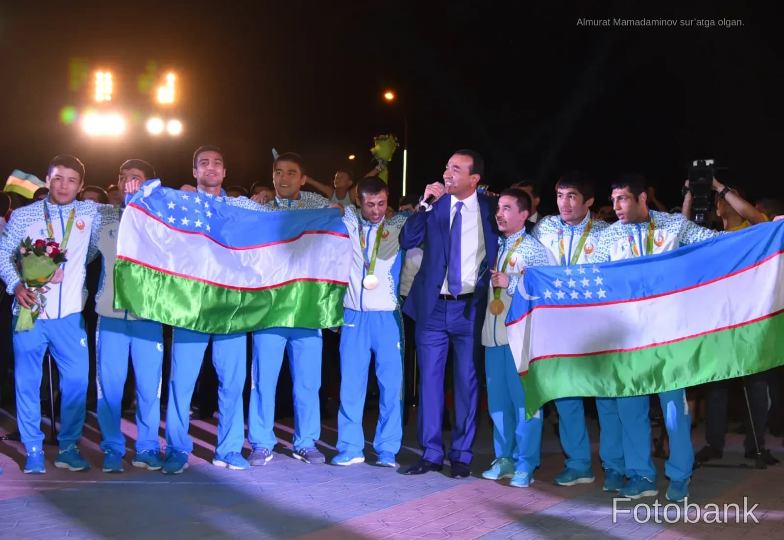 Athletes holding flags and celebrating