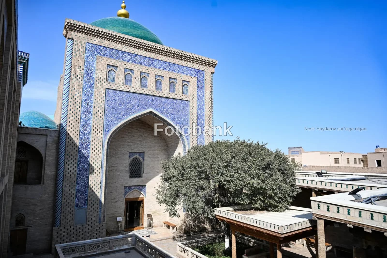 Traditional architecture with blue tilework and a green dome
