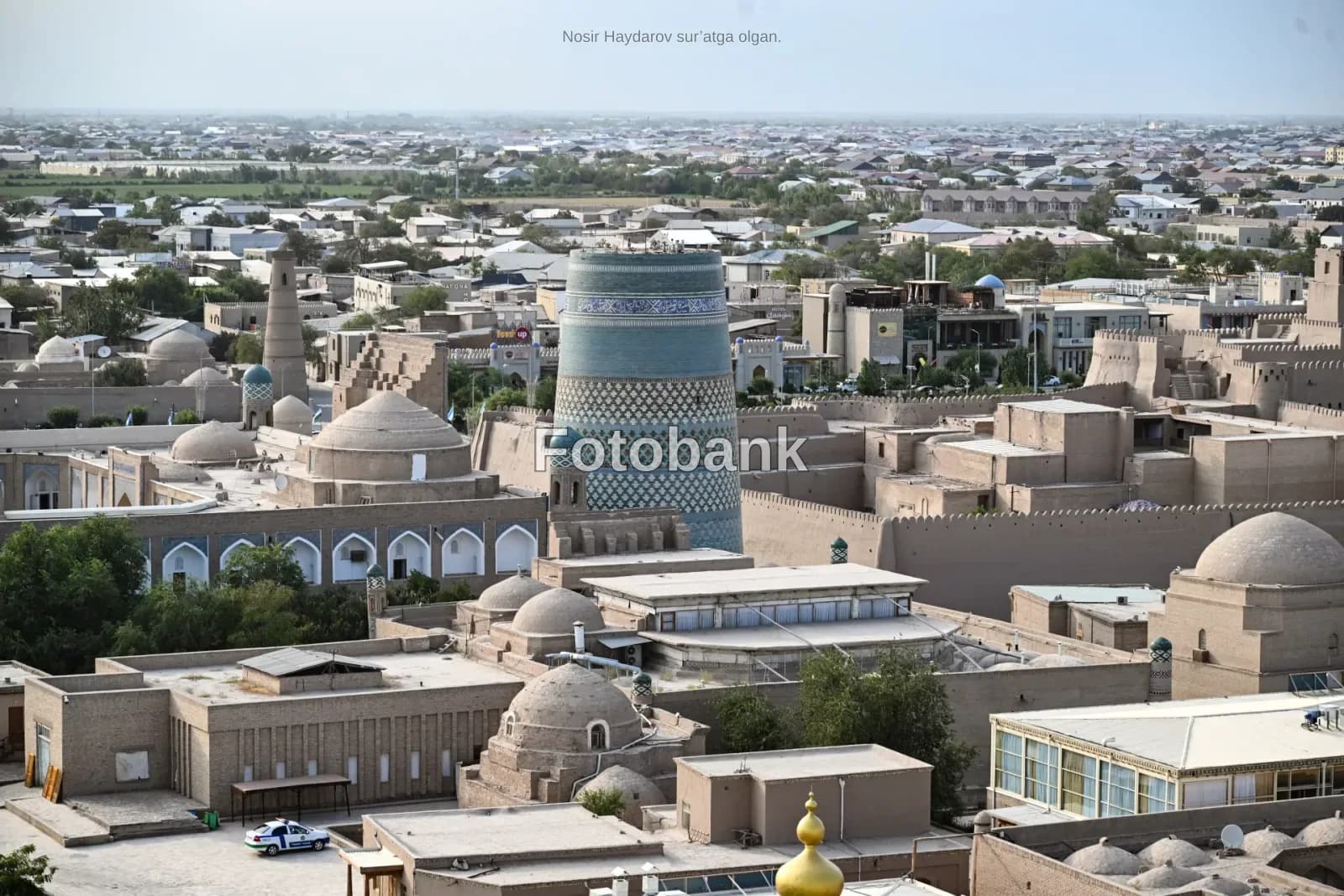 High angle panoramic view of historic city architecture with a large tiled minaret