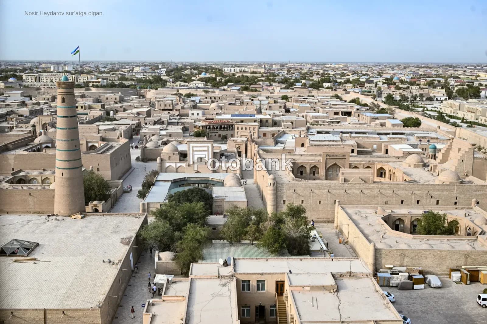 High angle panoramic view of historic city architecture with minaret and flat rooftops