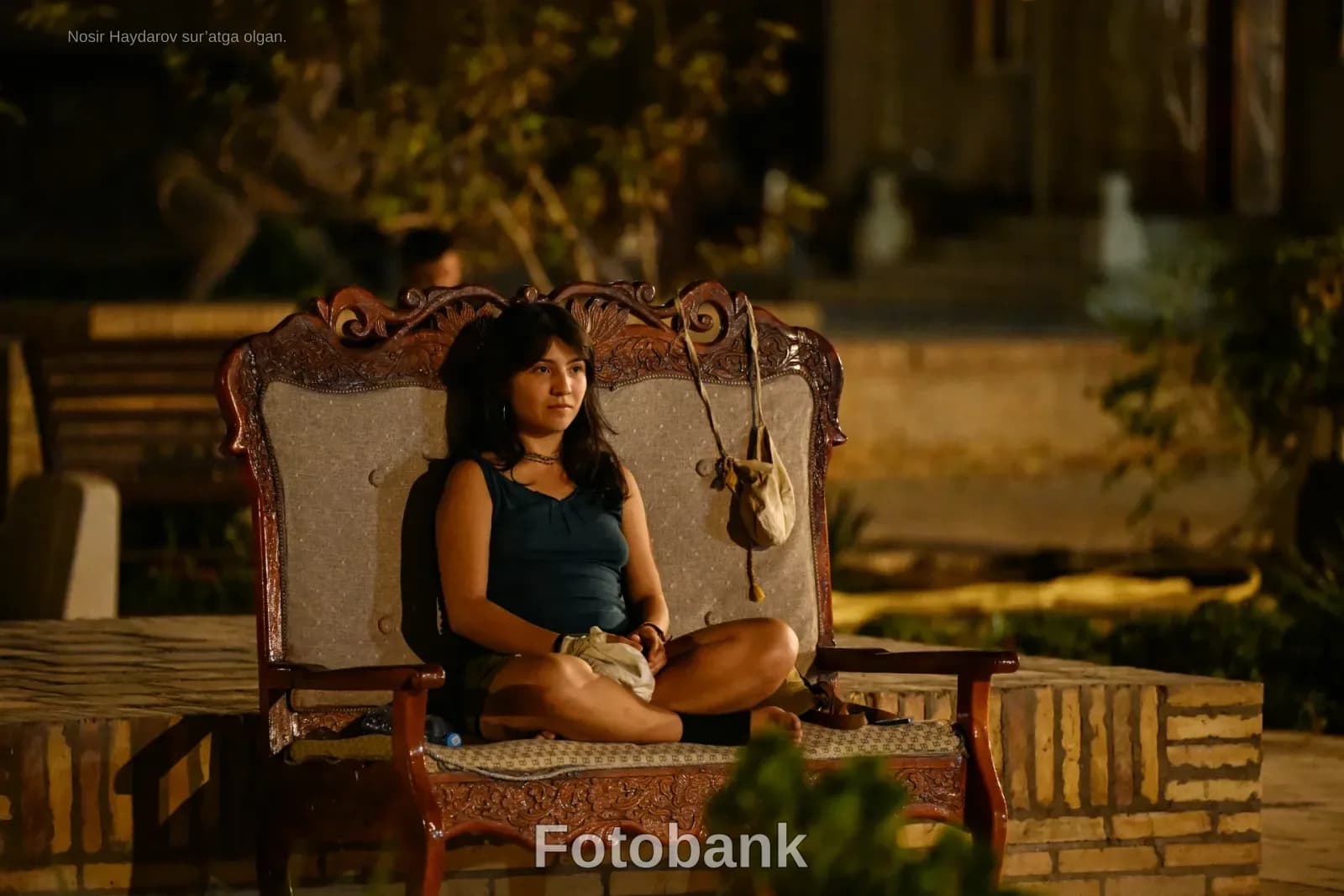 Person sitting outdoors at night