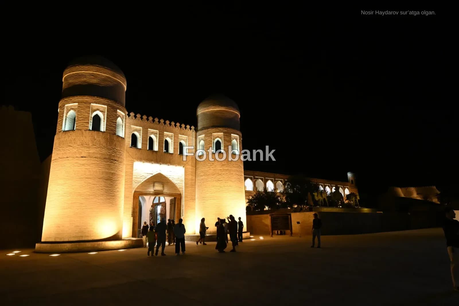 Illuminated historic fortress facade at night