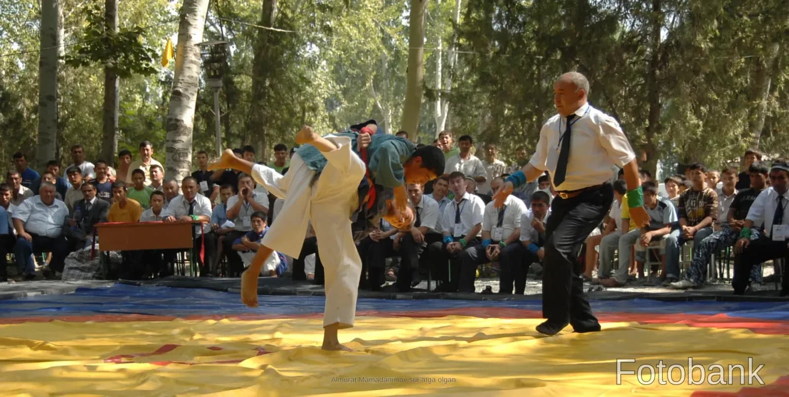 People engaged in a wrestling competition outdoors