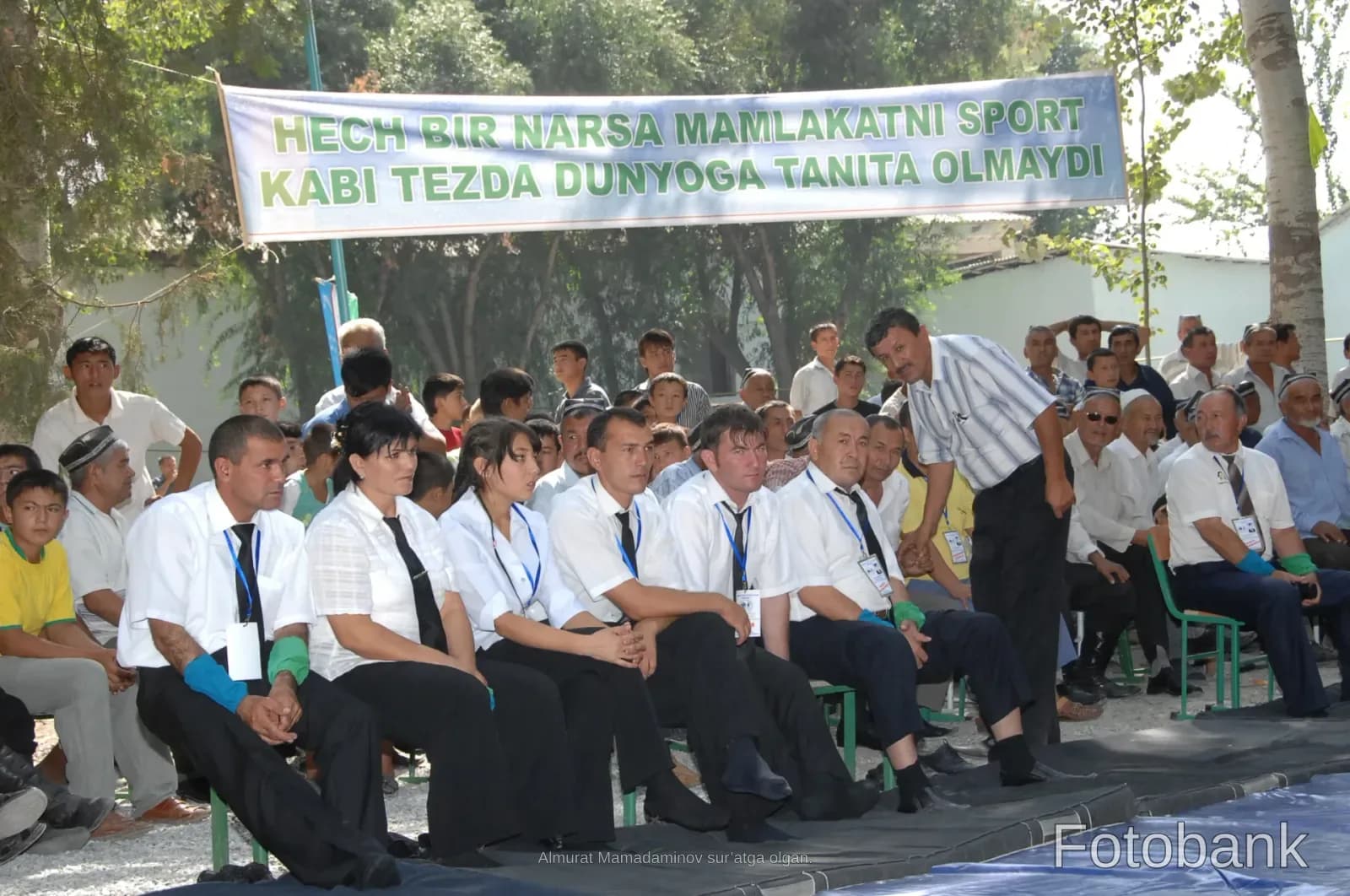 People gathered outdoors under a banner