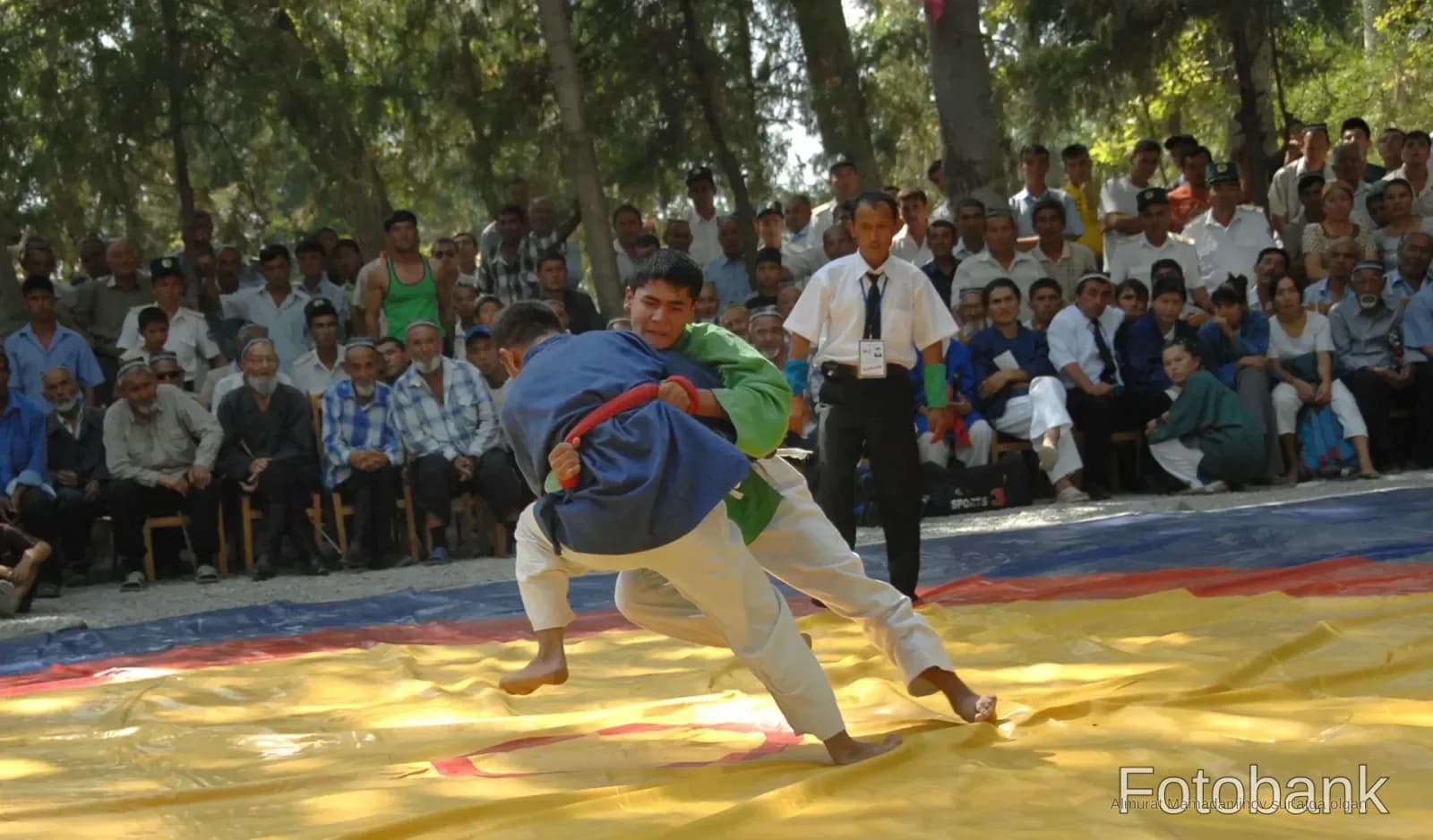 Competitors grapple during a wrestling match