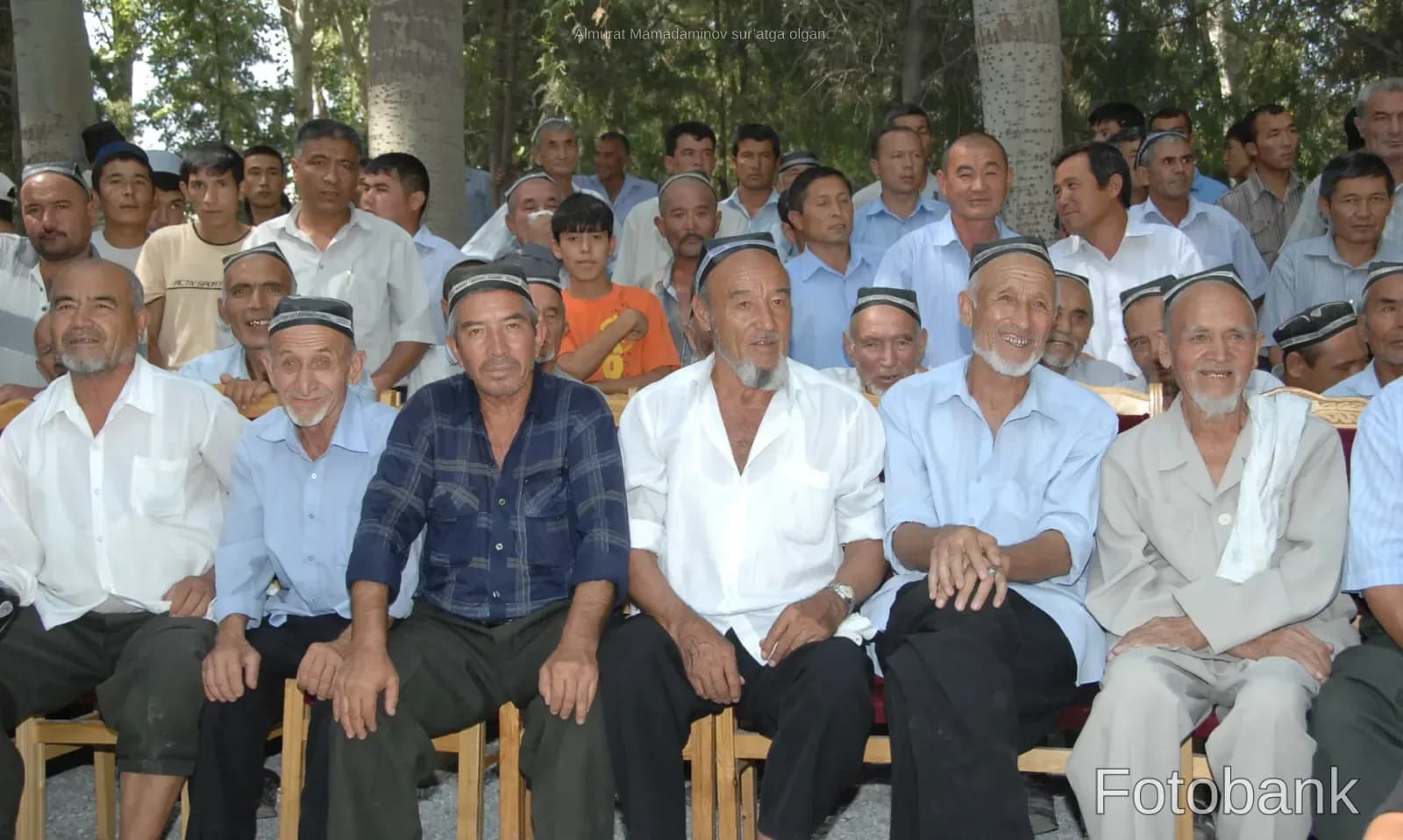 Group of men sitting outdoors