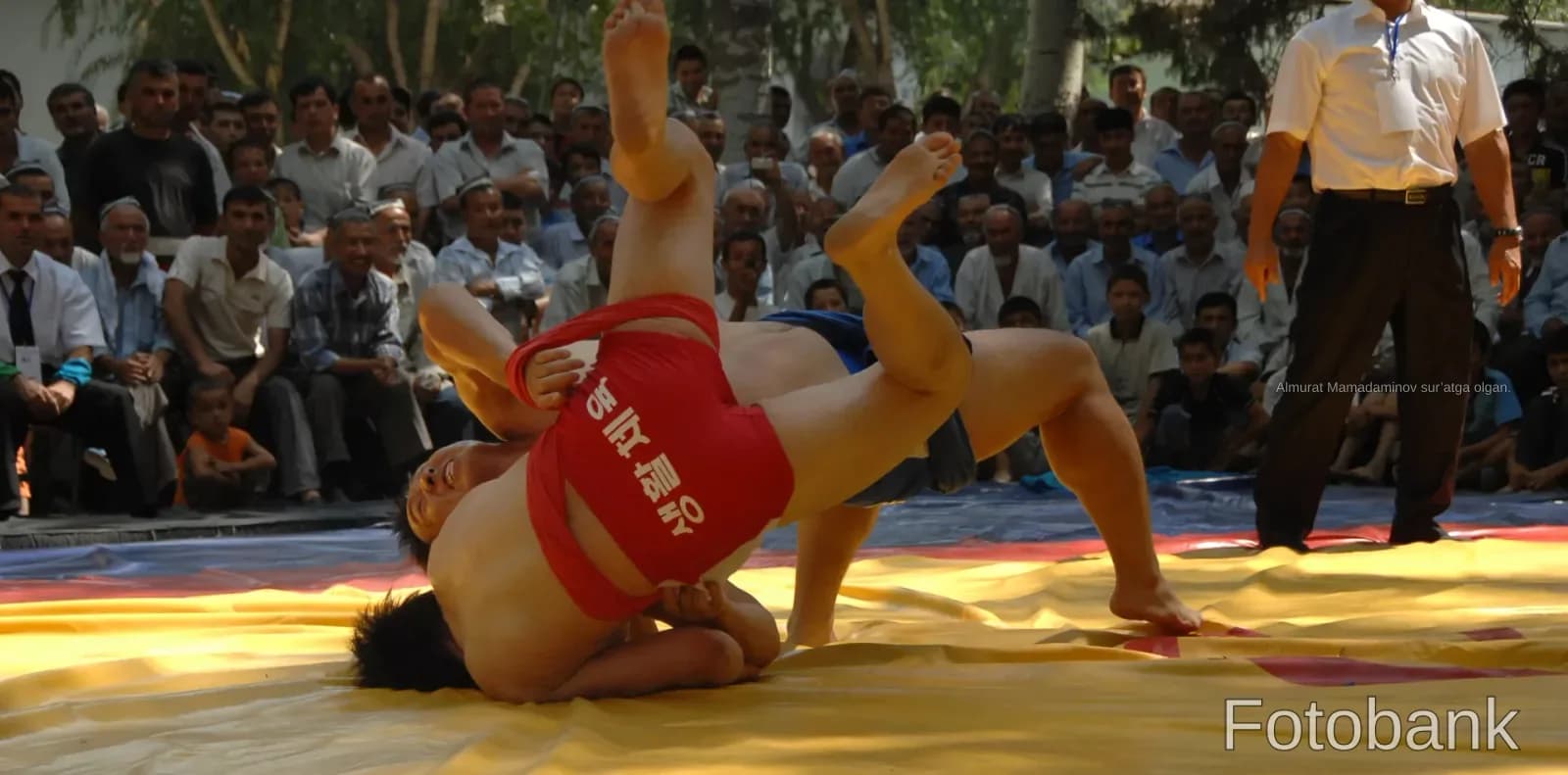 Wrestlers competing on a mat