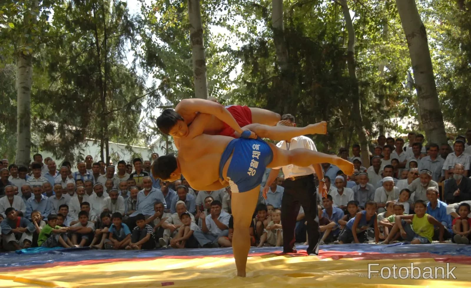 Wrestlers competing in a match outdoors