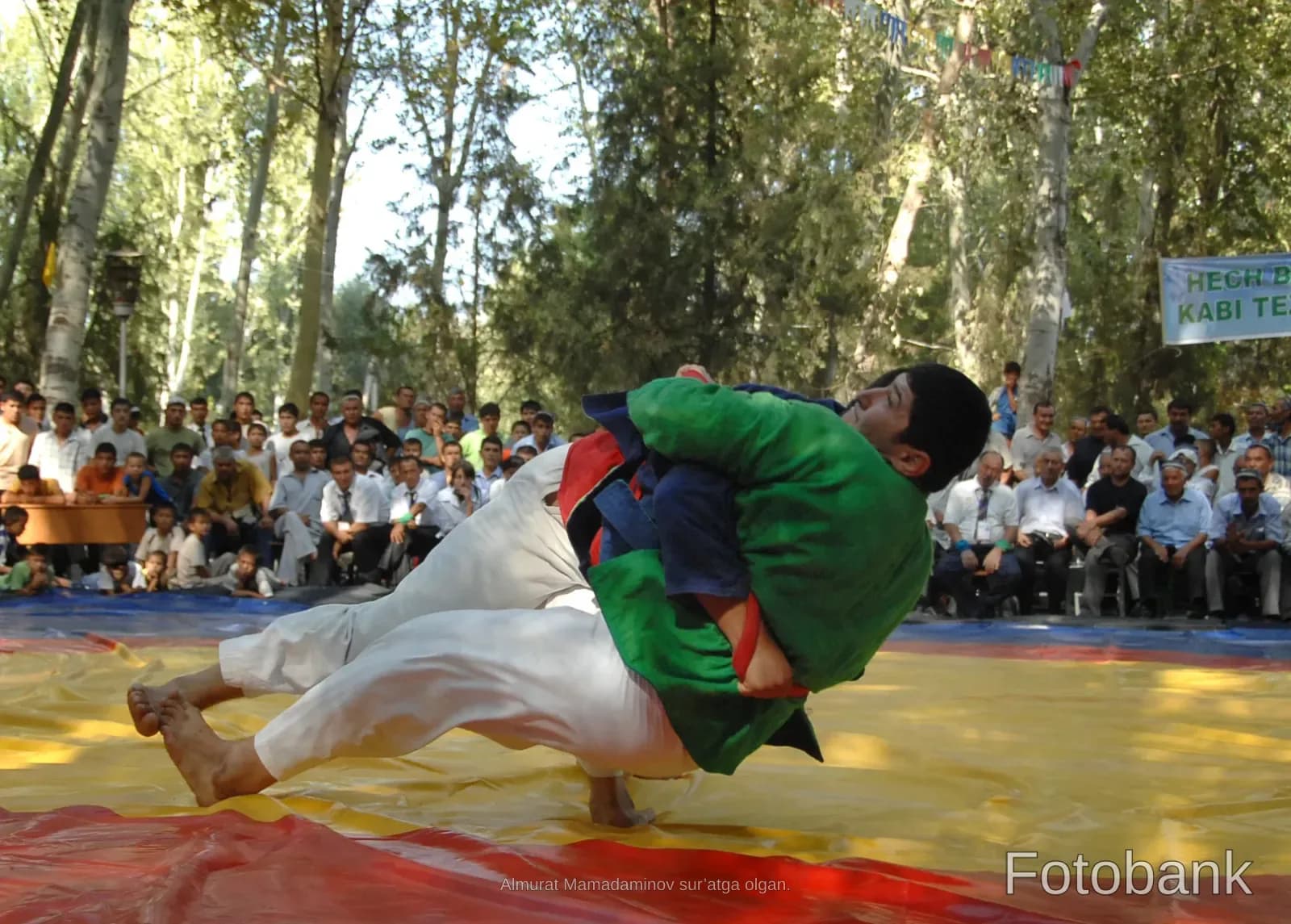 Men competing in a traditional wrestling match outdoors