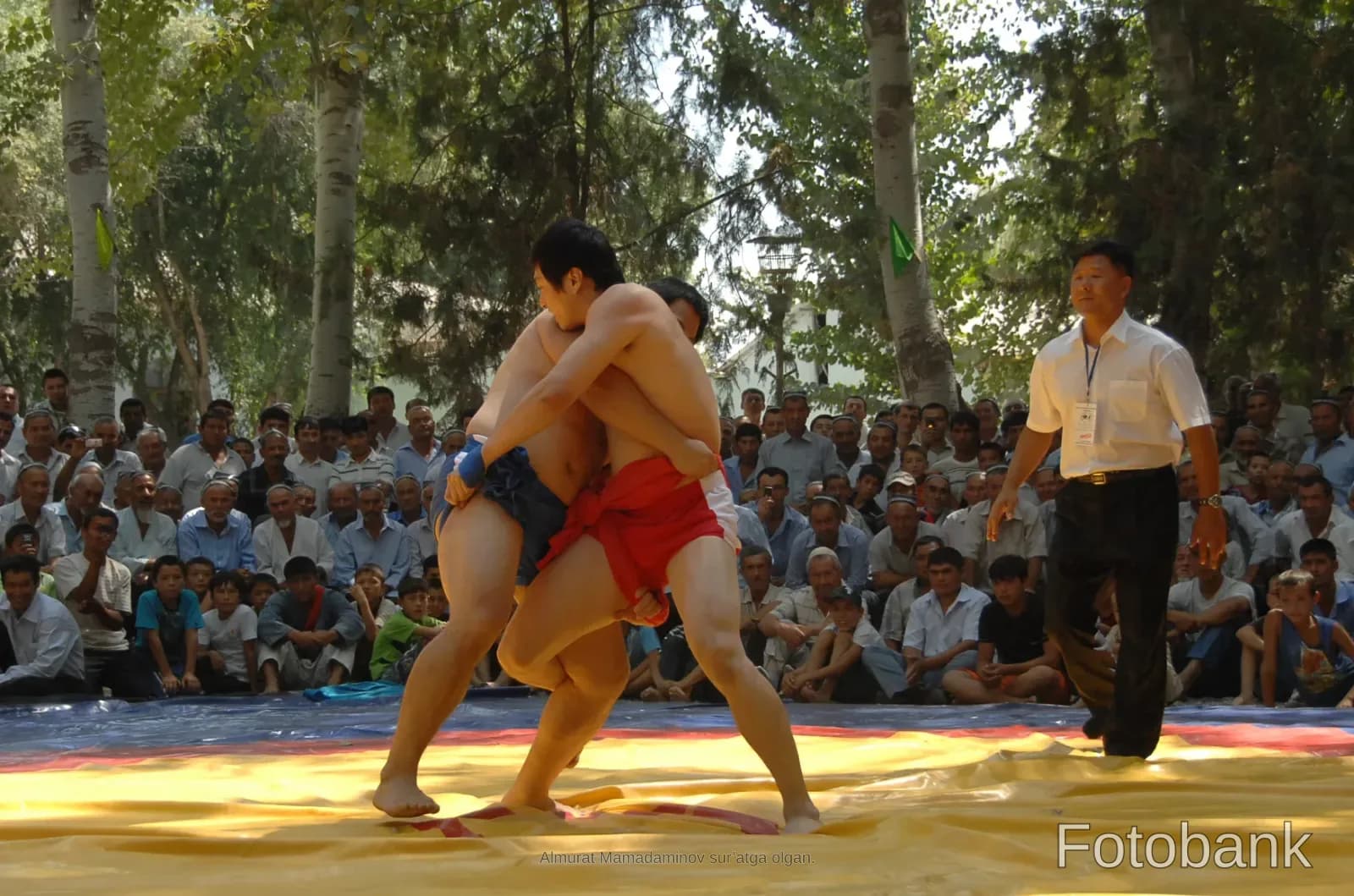 Two competitors grapple during a wrestling match