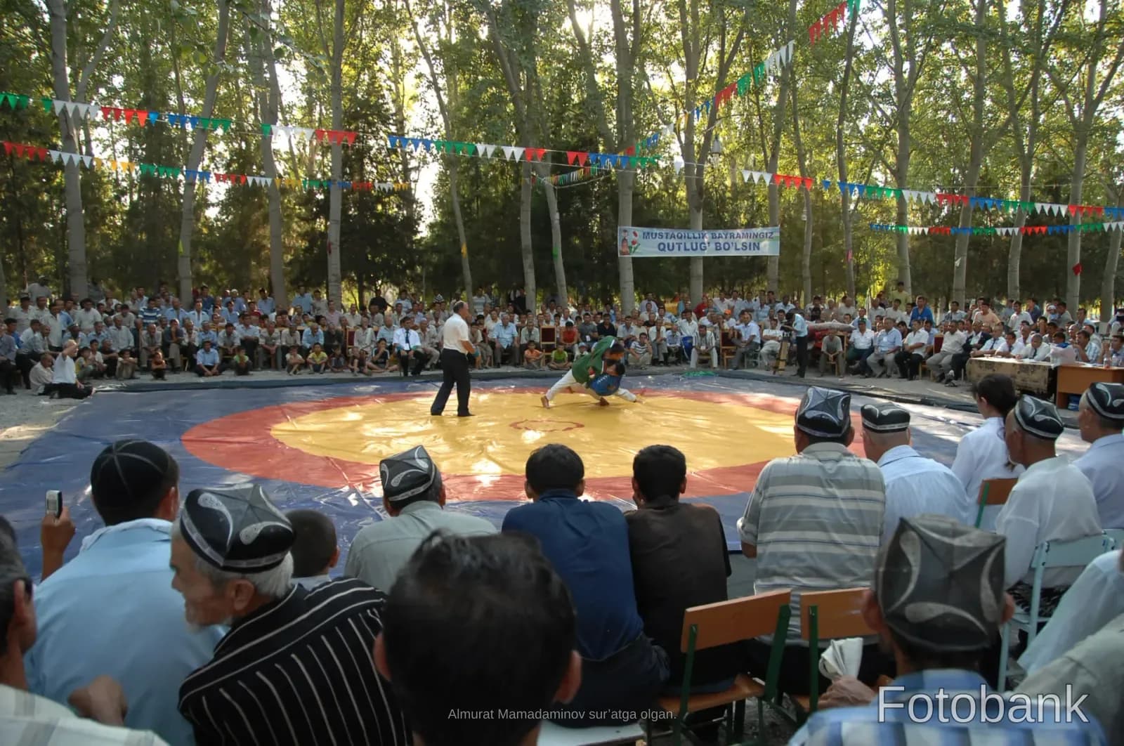 Traditional wrestling match outdoors with spectators