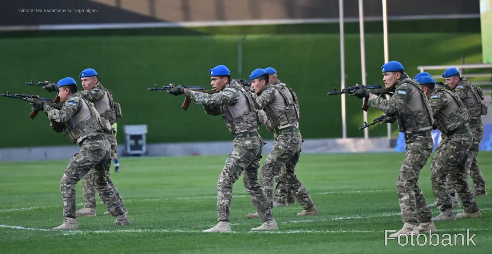 Group of soldiers in camouflage uniform with rifles on a field