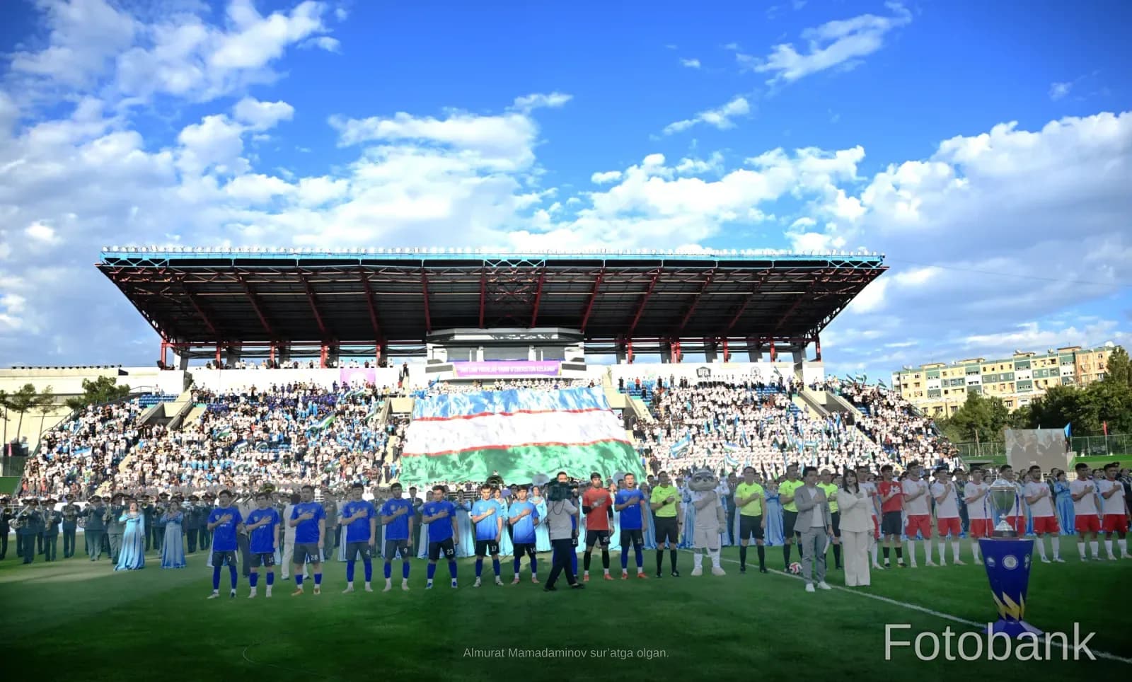 Athletes gathered on a stadium field during an event
