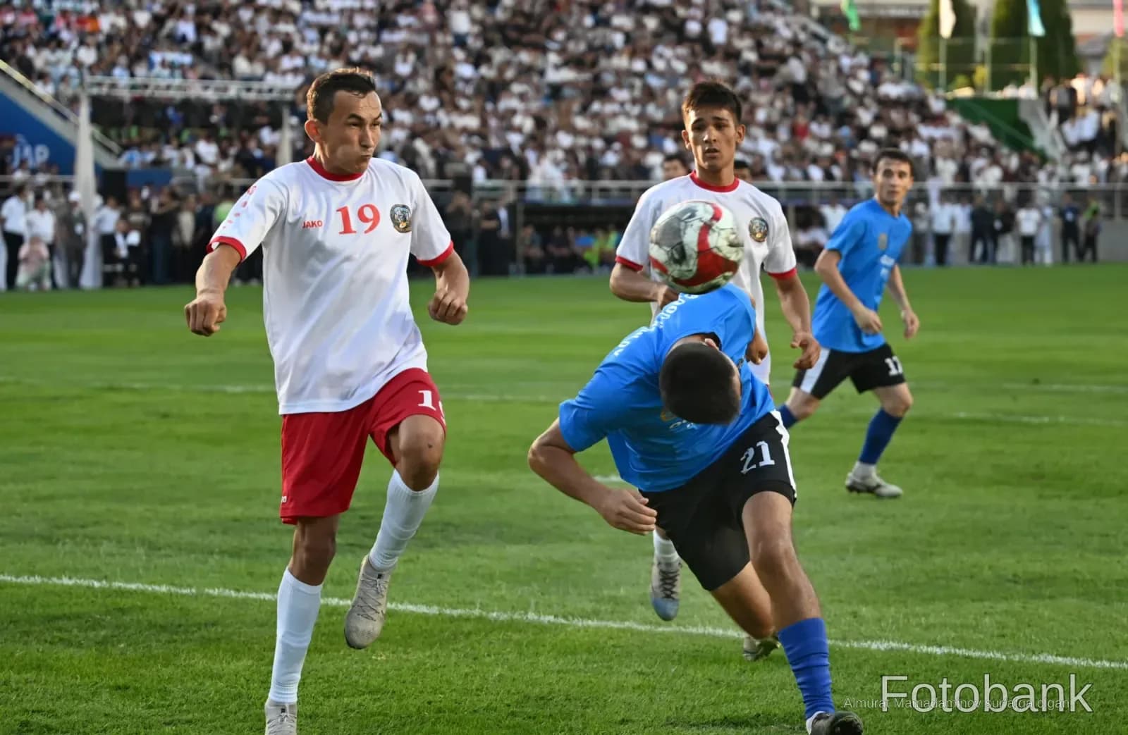 Football match action on a grassy field