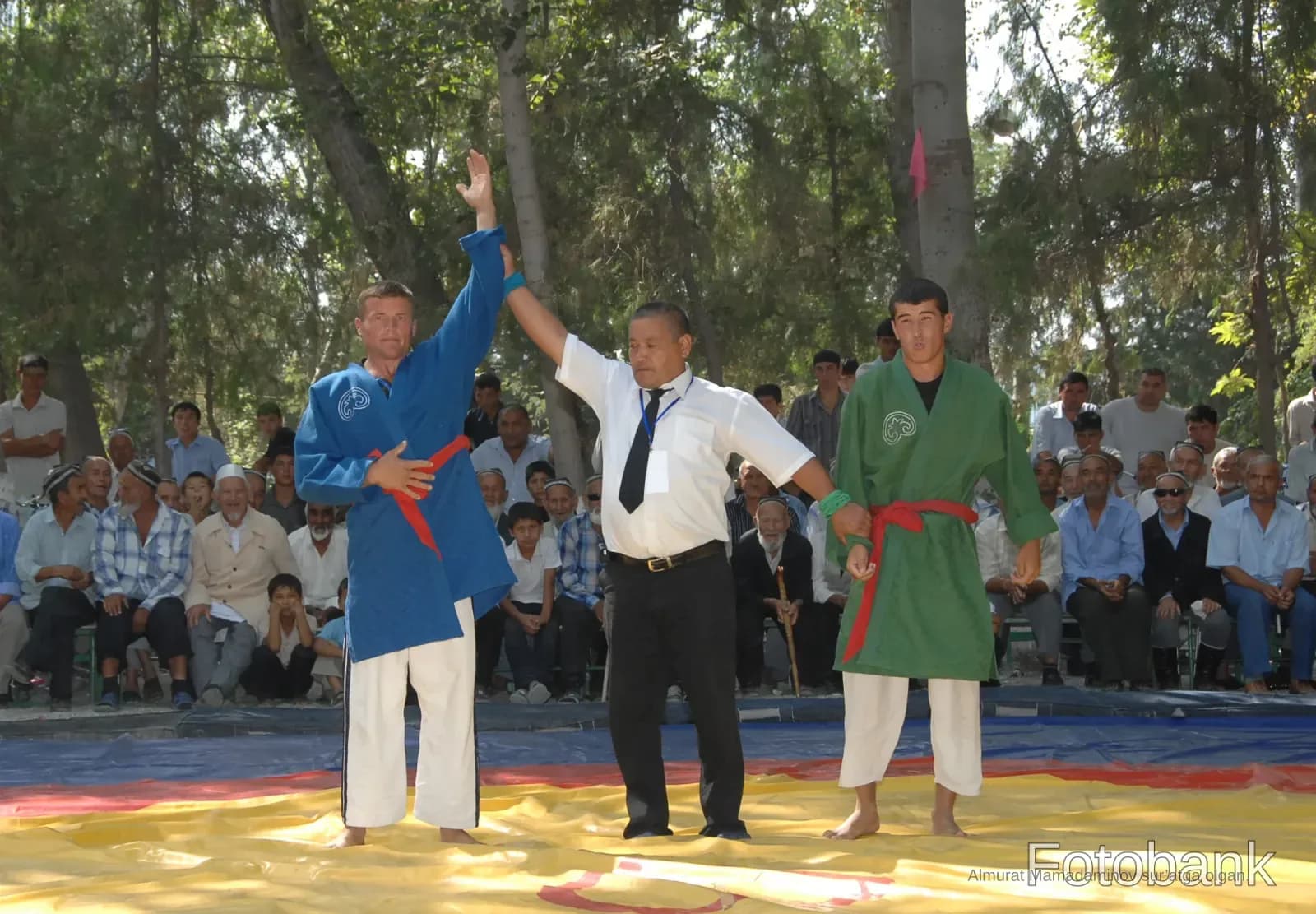 Referee raising the hand of a wrestling winner