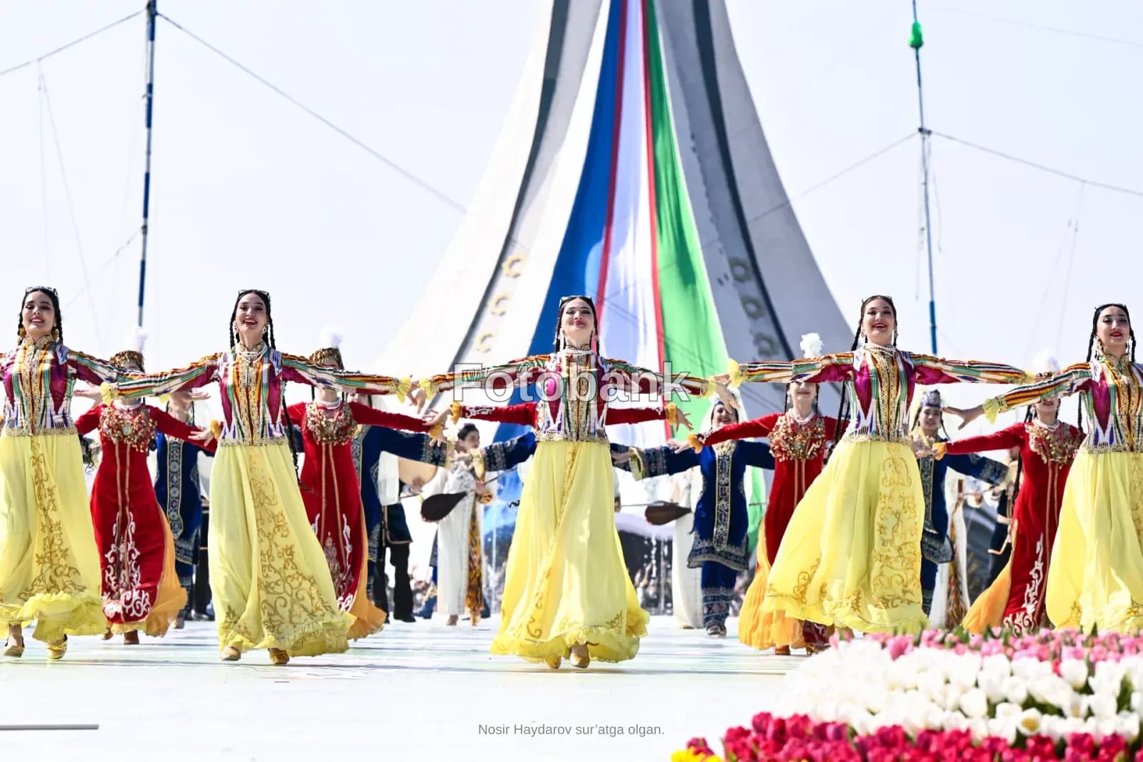 Performers in traditional clothing dancing outdoors