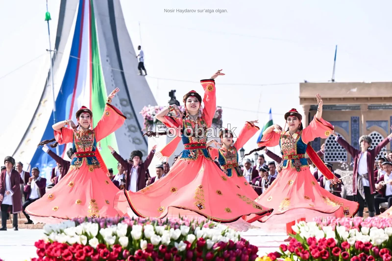 Performers in traditional clothing dancing outdoors