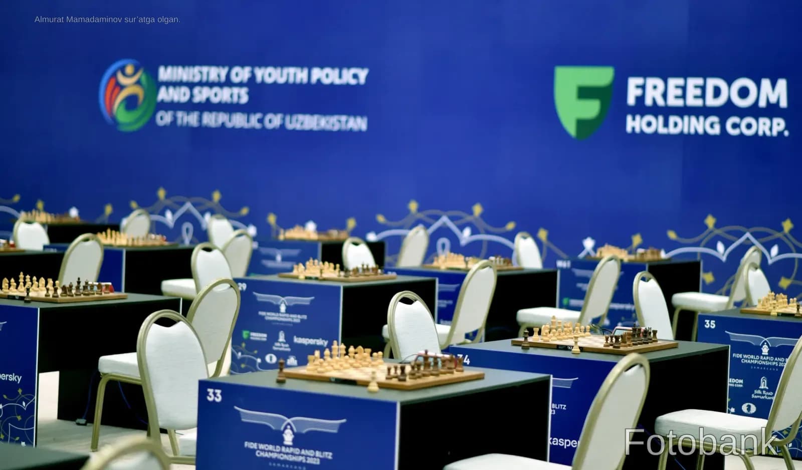 Chess boards and chairs set up in an indoor tournament hall