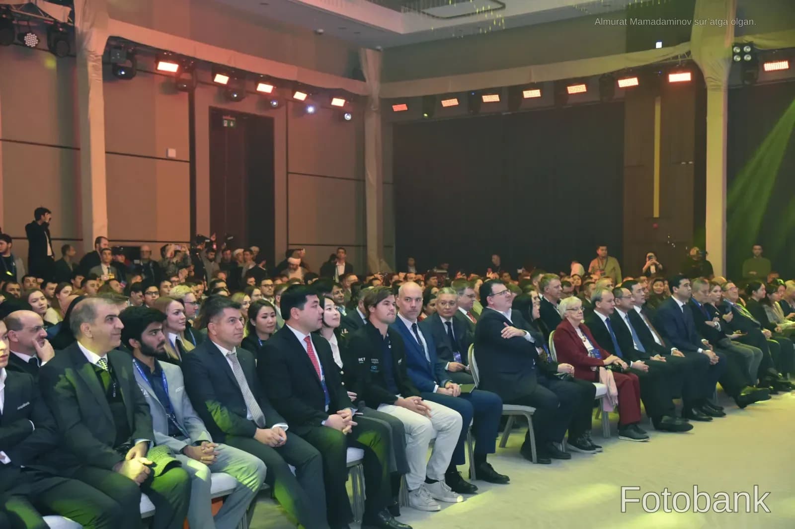 People attending a conference in a large hall
