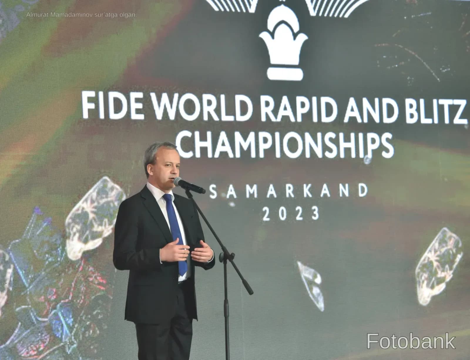 Man speaking at a podium during a championship event