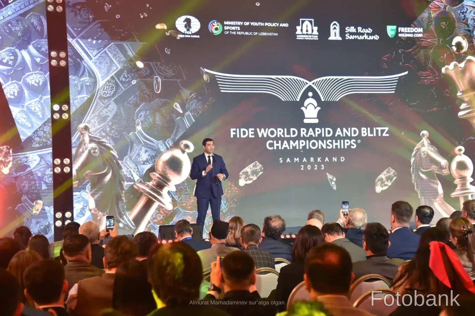 Person speaking on stage at championship event