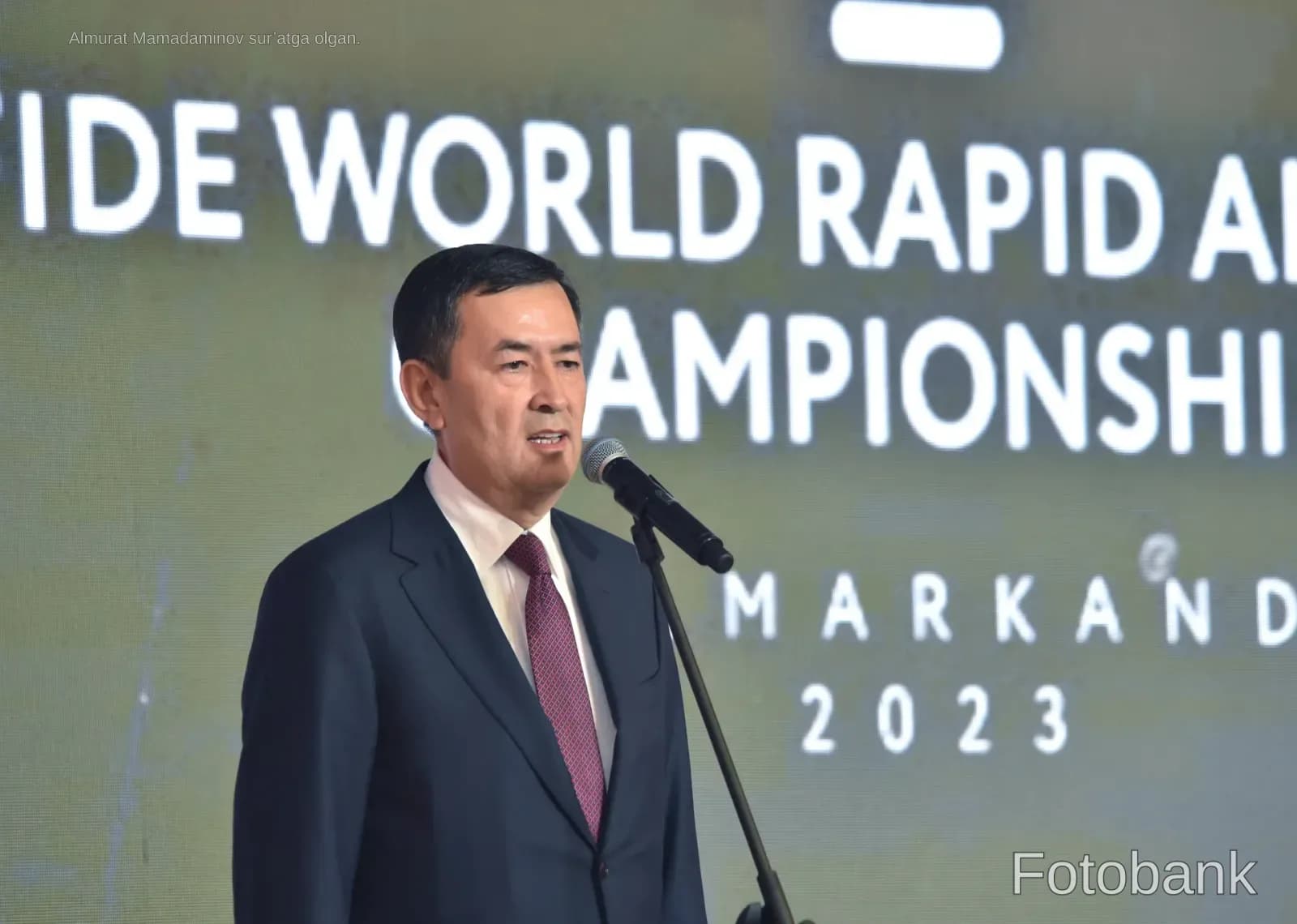 Man speaking into a microphone at an event