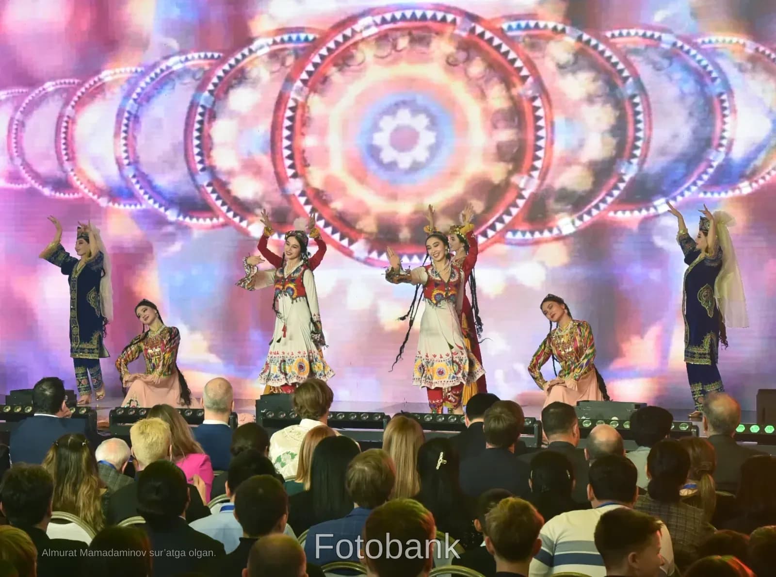 Performers in traditional clothing dancing on stage