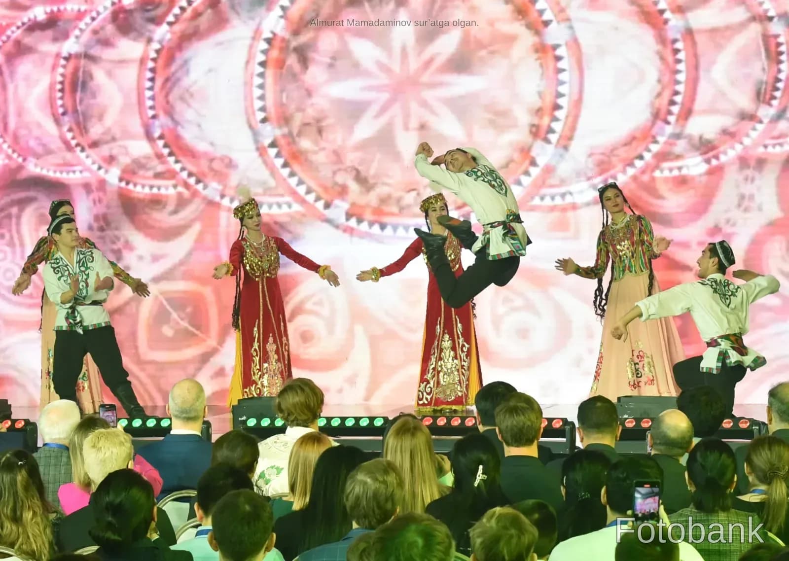 Performers in traditional clothing dancing on stage