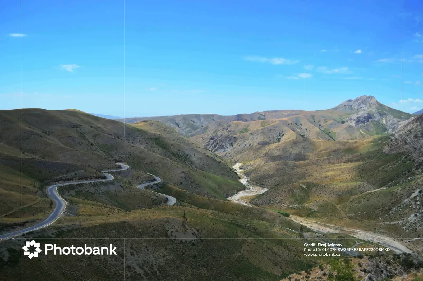 Winding mountain road through a valley landscape