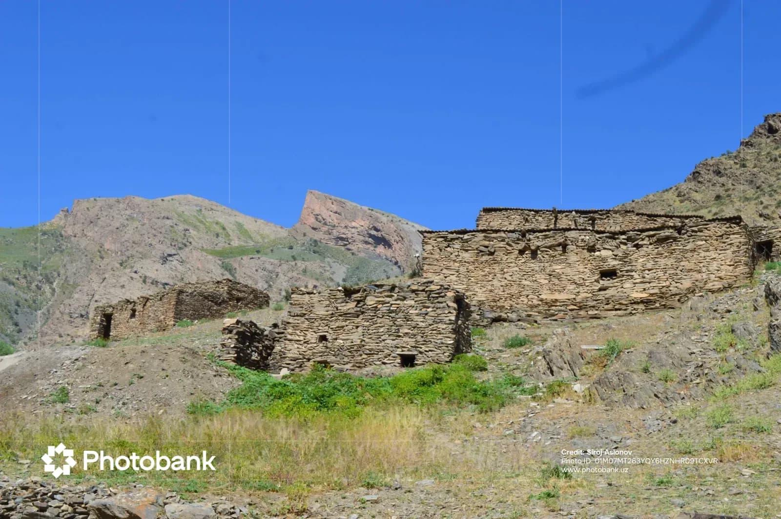 Stone structures in a mountainous landscape under a clear sky