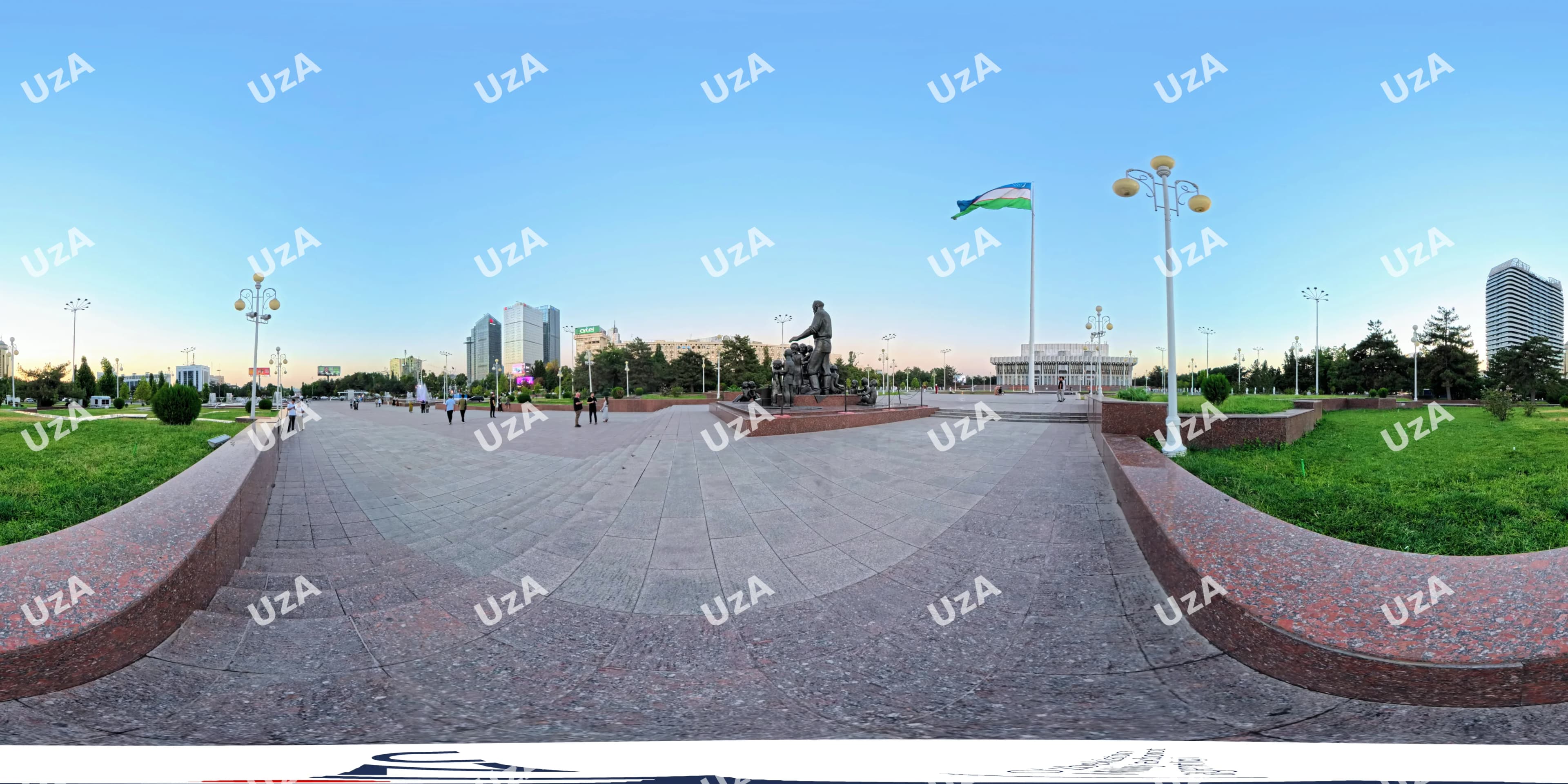 Public square with monument and flag in city