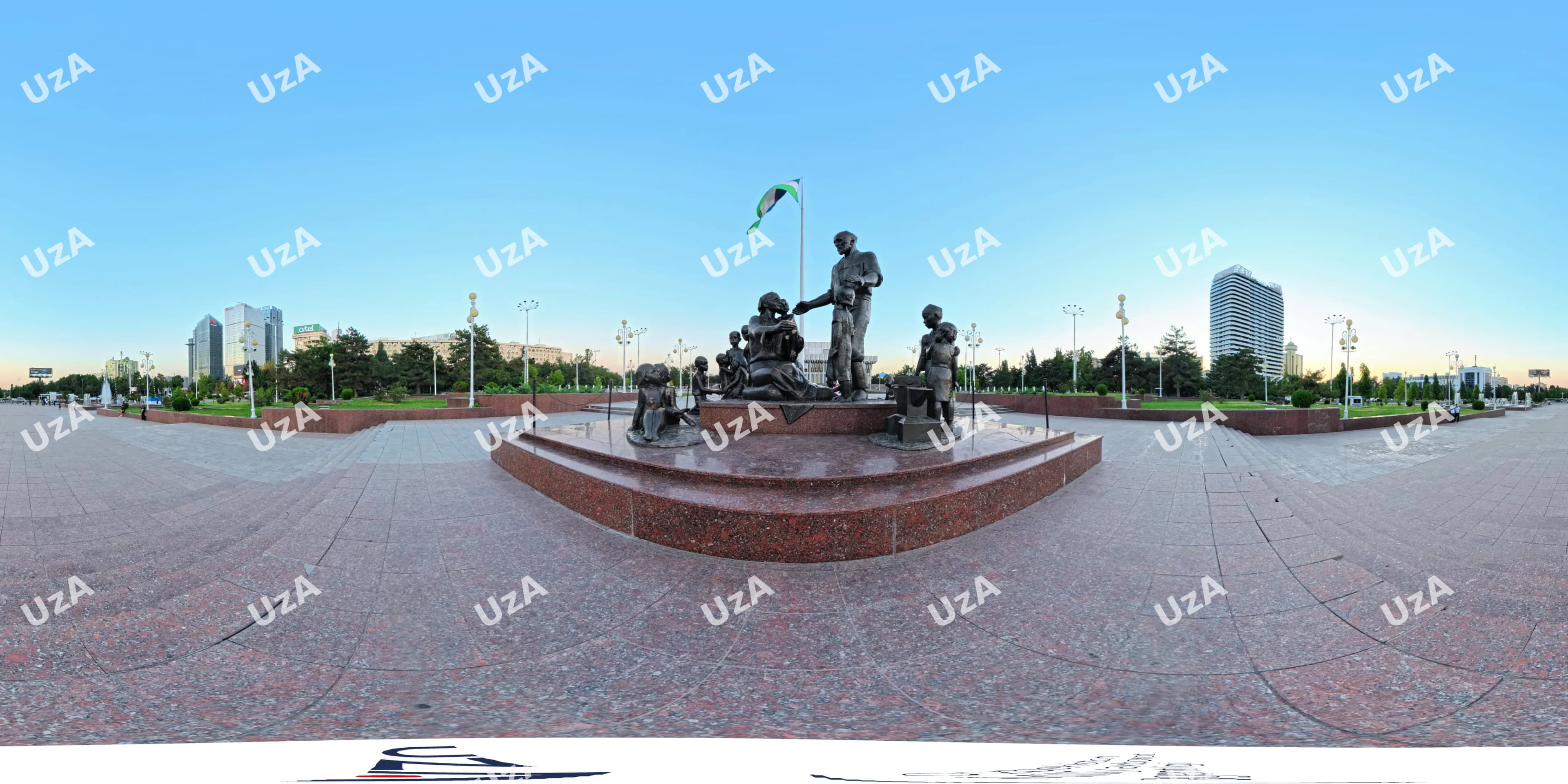 Bronze monument sculpture group on public square with flag