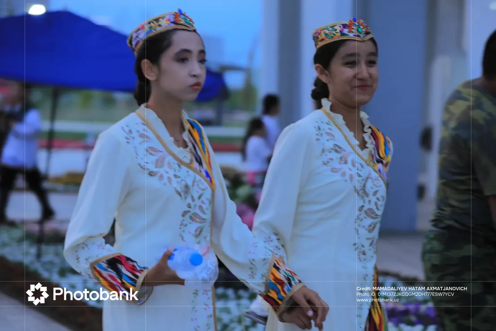 Two young women in traditional clothing walking outdoors
