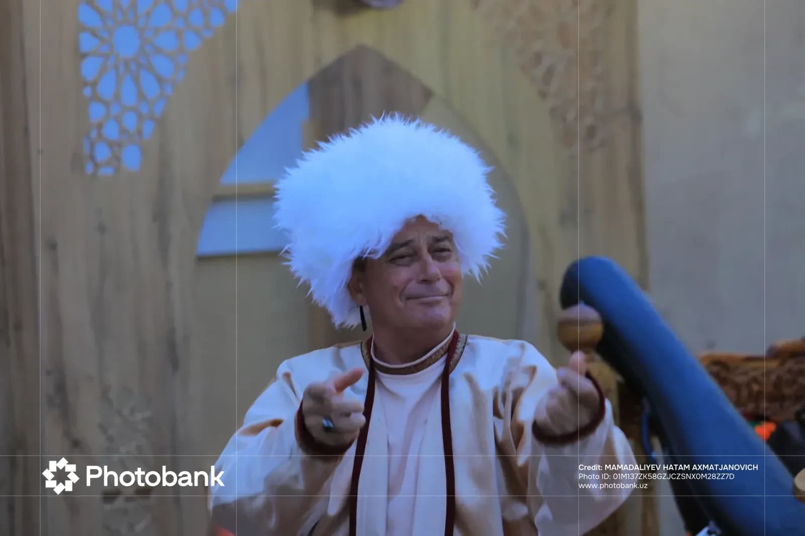 Man in traditional clothing and white fur hat