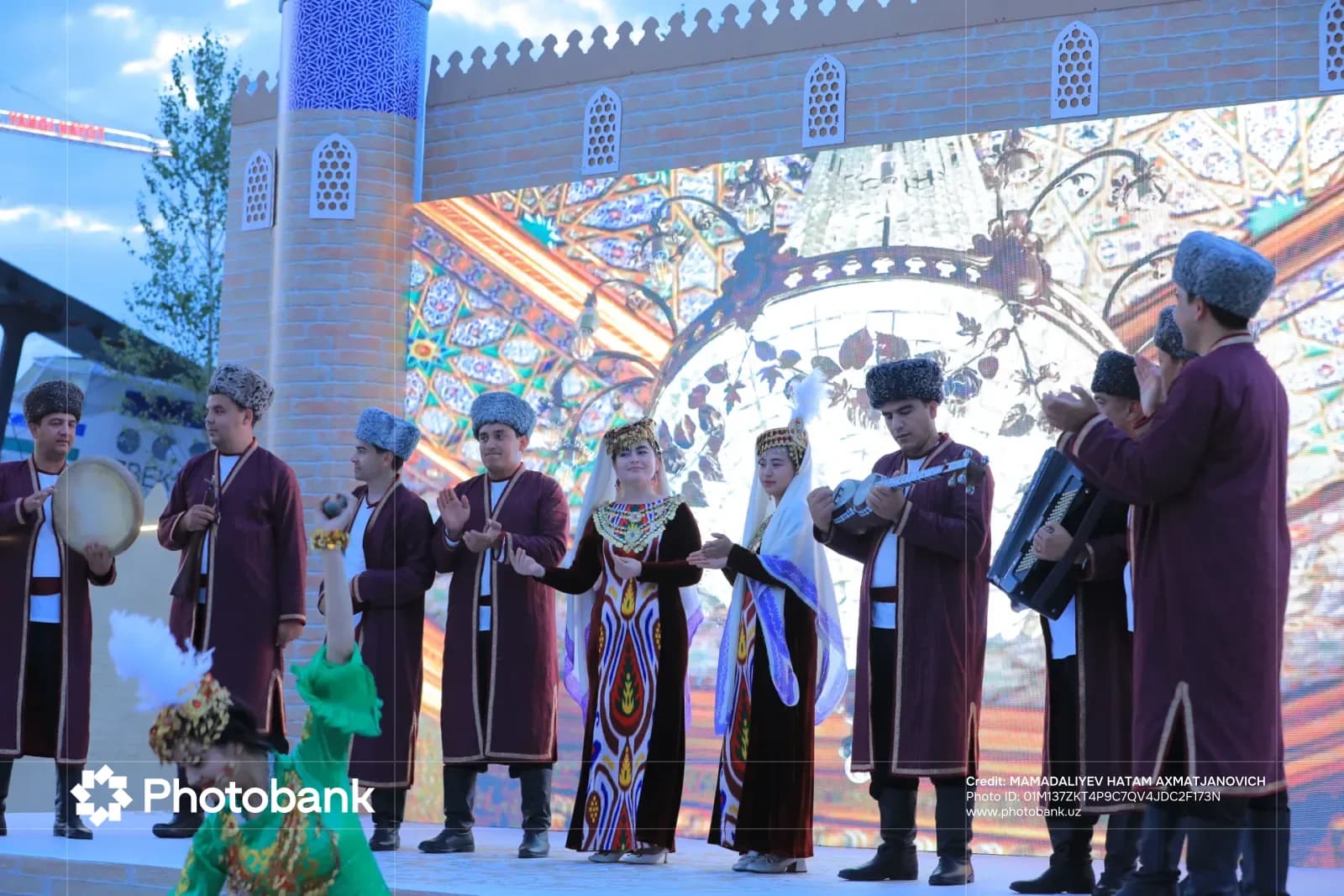 People in traditional clothing performing on a stage