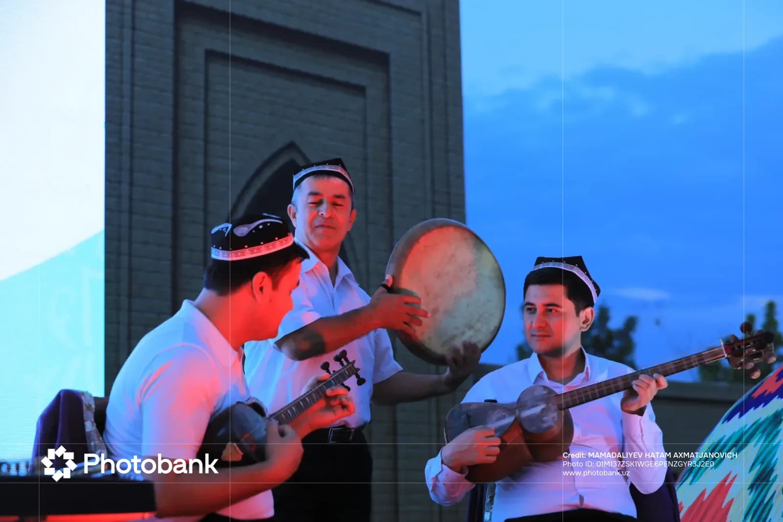 People playing traditional musical instruments outdoors